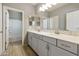 Modern bathroom with double vanity, tile flooring and a separate tub shower at 5660 N 188Th Ln, Litchfield Park, AZ 85340