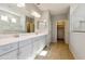 Elegant bathroom with double vanity, large mirror, and tile flooring at 5660 N 188Th Ln, Litchfield Park, AZ 85340