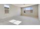Well-lit bedroom featuring carpet and two windows at 5660 N 188Th Ln, Litchfield Park, AZ 85340