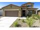 Two-story house with stone accents and a landscaped front yard at 5660 N 188Th Ln, Litchfield Park, AZ 85340