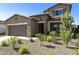 Two-story house with stone accents and a landscaped front yard at 5660 N 188Th Ln, Litchfield Park, AZ 85340