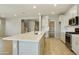 Modern kitchen with white cabinets, quartz countertops and stainless steel appliances at 5660 N 188Th Ln, Litchfield Park, AZ 85340