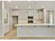 Modern kitchen with white cabinets, quartz countertops and stainless steel appliances at 5660 N 188Th Ln, Litchfield Park, AZ 85340