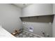 Laundry room with shelving, tile flooring and hookups for washer and dryer at 5660 N 188Th Ln, Litchfield Park, AZ 85340