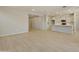 Open concept living room with wood-look flooring and kitchen view at 5660 N 188Th Ln, Litchfield Park, AZ 85340