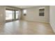Bright living room with sliding glass doors and wood-look floors at 5660 N 188Th Ln, Litchfield Park, AZ 85340