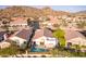 Aerial view of a community with desert landscape, showing a home with a pool at 6334 E Viewmont Dr # 5, Mesa, AZ 85215