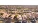 An aerial view of a residential neighborhood with houses and a golf course visible in the background at 6334 E Viewmont Dr # 5, Mesa, AZ 85215