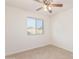 Bedroom with window, ceiling fan and closet at 708 E Garnet Ave, Mesa, AZ 85204