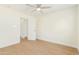 Bedroom with door to bathroom and ceiling fan at 8311 E Angus Dr, Scottsdale, AZ 85251