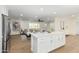 Open concept kitchen with island and view into living room at 8311 E Angus Dr, Scottsdale, AZ 85251