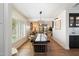 Bright dining room with a long table, wood floors, and white shiplap walls at 8607 N Farview Dr, Scottsdale, AZ 85258