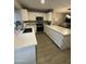 Bright kitchen featuring white cabinets, stainless steel appliances, and quartz countertops at 921 W University Dr # 1136, Mesa, AZ 85201