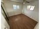 Second bedroom with mirrored closet doors and wood-look floors at 9501 E Broadway Rd # 107, Mesa, AZ 85208