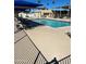 Community pool with tables, chairs and shade umbrellas at 9501 E Broadway Rd # 107, Mesa, AZ 85208