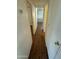 Long hallway with wood-look laminate flooring and access to bedrooms at 9501 E Broadway Rd # 107, Mesa, AZ 85208