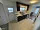 Efficient kitchen featuring ample cabinetry and a view into the adjacent dining area at 9501 E Broadway Rd # 107, Mesa, AZ 85208