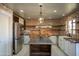 Modern kitchen with exposed brick, butcher block counters, and stainless steel appliances at 9712 W Riverside Ave, Tolleson, AZ 85353