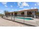 Community pool with surrounding patio and gated access at 100 N Vulture Mine Rd # 101, Wickenburg, AZ 85390