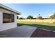 Backyard view showcasing a grassy area and patio at 10620 W Clair Dr, Sun City, AZ 85351