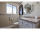 Clean bathroom with single sink and octagon mirror at 10620 W Clair Dr, Sun City, AZ 85351