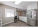 Modern kitchen with white cabinets, stainless steel appliances, and wood-look floors at 10620 W Clair Dr, Sun City, AZ 85351