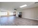 Spacious living room with wood-look floors and large windows at 10620 W Clair Dr, Sun City, AZ 85351