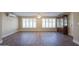 Spacious living area with wood-look floors and large windows at 10620 W Clair Dr, Sun City, AZ 85351