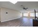 Bright living room featuring wood-look floors and ceiling fan at 10620 W Clair Dr, Sun City, AZ 85351