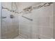 Shower stall with tiled walls and grab bars at 10620 W Clair Dr, Sun City, AZ 85351