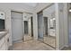 Bathroom with double sinks, large mirrors, and walk-in closet at 10934 E Becker Ln, Scottsdale, AZ 85259