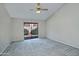 Bedroom with carpeted floor, ceiling fan, and sliding glass doors at 10934 E Becker Ln, Scottsdale, AZ 85259