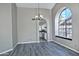 Dining area with wood-look floors and arched window and kitchen views at 10934 E Becker Ln, Scottsdale, AZ 85259