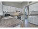 Bright kitchen with white cabinets, granite countertops, and stainless steel appliances at 10934 E Becker Ln, Scottsdale, AZ 85259