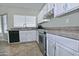 Kitchen with white cabinets, stainless steel appliances, and tile floors at 10934 E Becker Ln, Scottsdale, AZ 85259