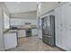 Kitchen with white cabinets, stainless steel appliances, and tile floors at 10934 E Becker Ln, Scottsdale, AZ 85259