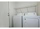 Laundry room with washer, dryer, and shelving at 10934 E Becker Ln, Scottsdale, AZ 85259