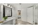 Bathroom with vanity, mirror, and access to other rooms at 11022 W Boswell Blvd, Sun City, AZ 85373