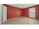 Simple bedroom with red walls and tile floors at 11022 W Boswell Blvd, Sun City, AZ 85373