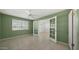 Bedroom with green walls and tile floors at 11022 W Boswell Blvd, Sun City, AZ 85373