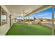 Covered patio with artificial turf and ceiling fan at 11022 W Boswell Blvd, Sun City, AZ 85373