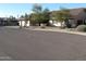 Single-story home with tile roof, attached garage, and mature trees at 1112 E Shepherds Way, Casa Grande, AZ 85122