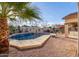 Inviting backyard oasis featuring a sparkling pool, patio, and lush landscaping at 11122 N 165Th Ave, Surprise, AZ 85388