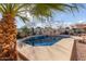 Relaxing backyard with a sparkling pool, palm trees, and a patio area at 11122 N 165Th Ave, Surprise, AZ 85388