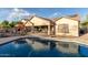 Inviting backyard oasis with sparkling pool, patio, and lush landscaping at 11122 N 165Th Ave, Surprise, AZ 85388