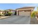 Single-story home with a two-car garage and desert landscaping at 11122 N 165Th Ave, Surprise, AZ 85388