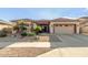 Single-story home with two-car garage and desert landscaping at 11122 N 165Th Ave, Surprise, AZ 85388