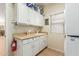 Laundry room with cabinets, sink, and additional storage at 11122 N 165Th Ave, Surprise, AZ 85388