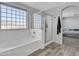 Bathroom with soaking tub, shower, and modern flooring at 11506 E Sylvan Ave, Mesa, AZ 85212