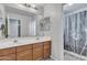 Double vanity bathroom with shower and updated cabinets at 11506 E Sylvan Ave, Mesa, AZ 85212